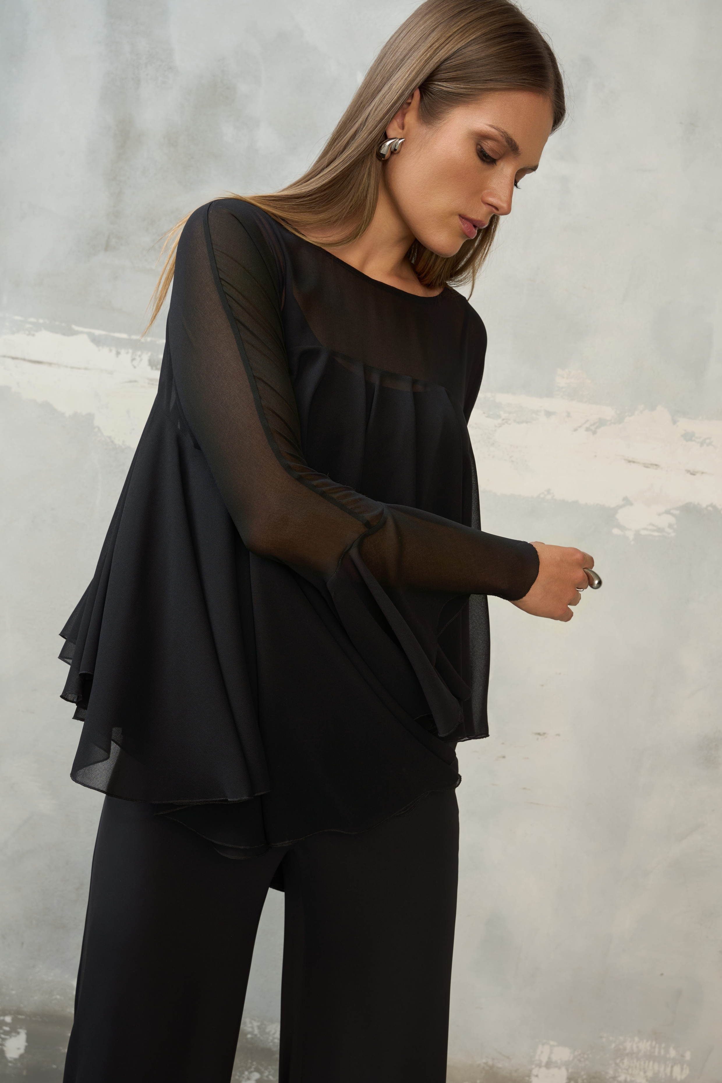 Czarna bluzka z falbanami EZURI w stylizacji ze spodniami