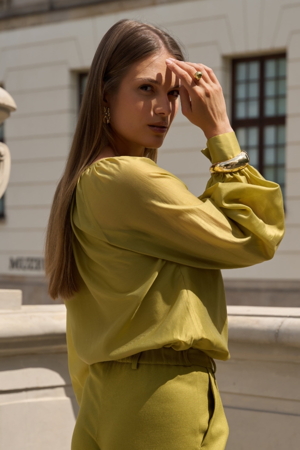 Kobieta w limonkowej bluzce EZURI z naturalnym połyskiem